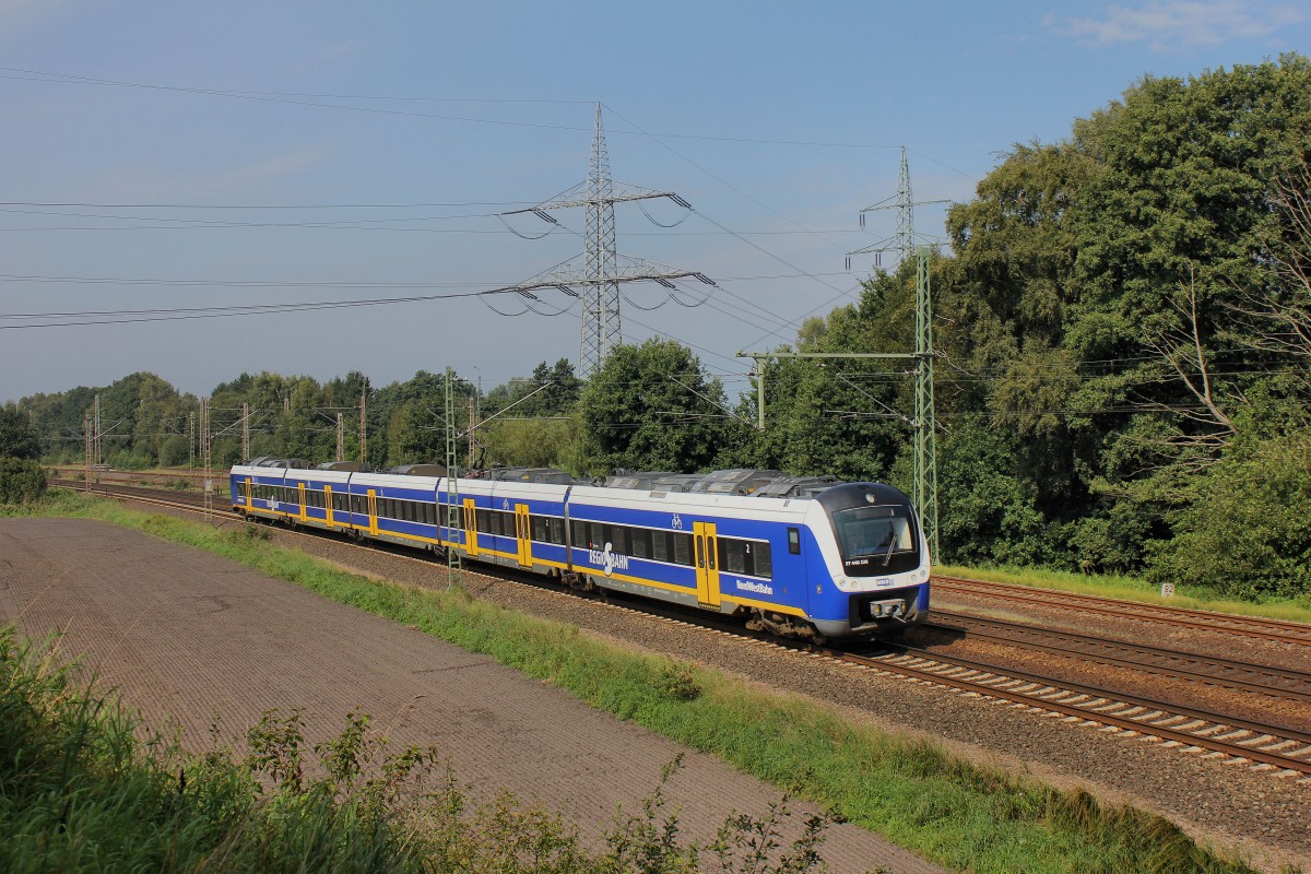 Der ET 440 226 der NWB hat den Bahnhof Langwedel und kommt am 12.09.2015 durch Langwedel-Förth gefahren.